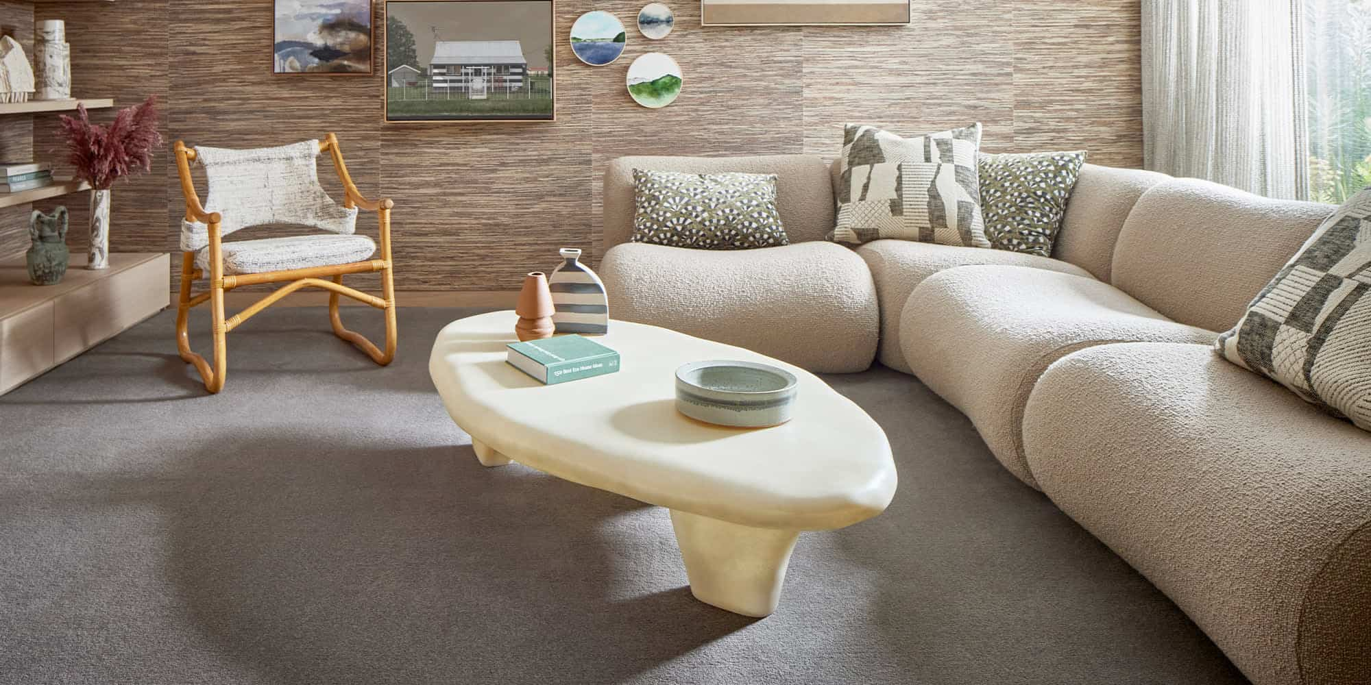 a living room with a couch and a coffee table on carpet