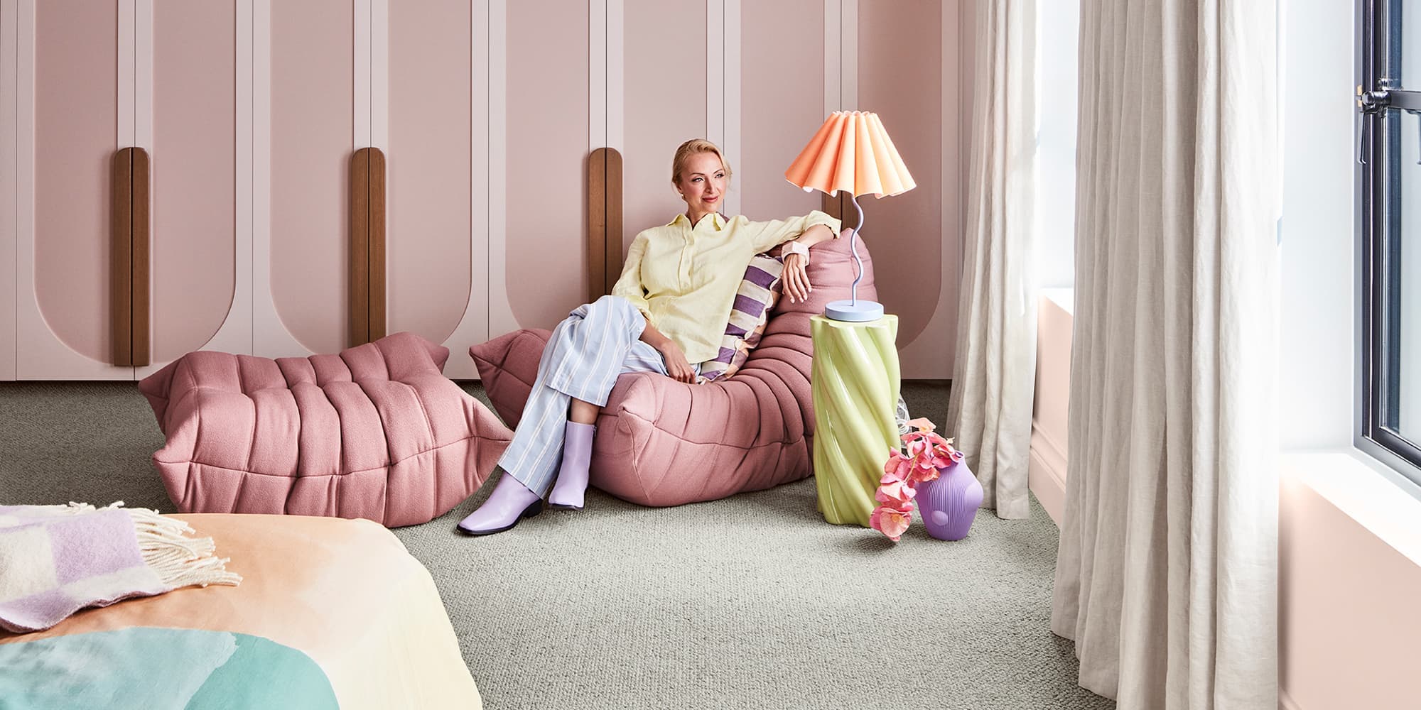 a woman sitting on a bean bag chair on carpet