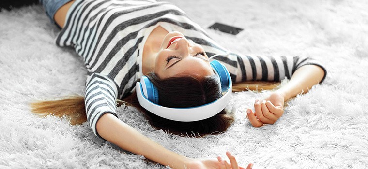 Woman laying on her back on white coloured carpet.