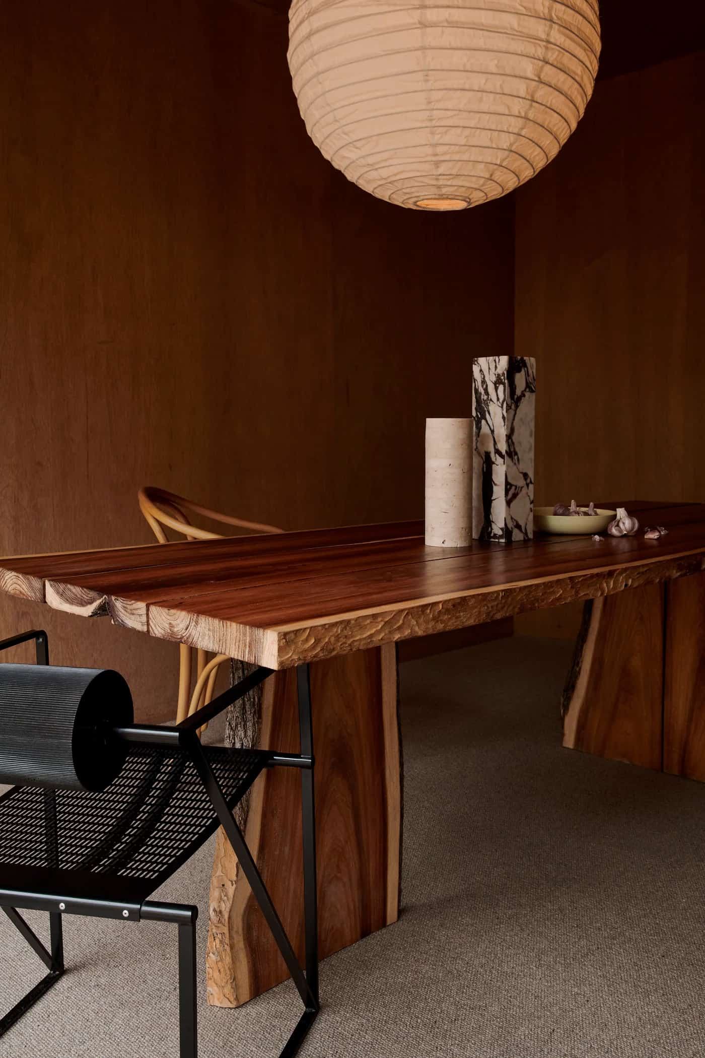 a table with a chair and a lamp on carpet